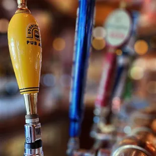 a row of beer taps
