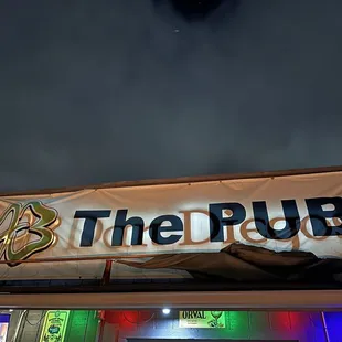 the front of the pub lit up at night