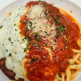 Chicken parmesan over linguine pasta