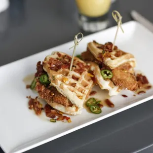 a plate of waffles with bacon and jalapenos