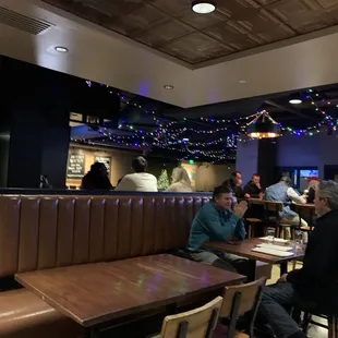 people sitting at tables in a restaurant