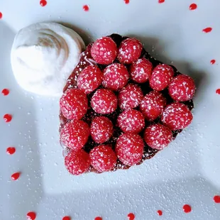 a dessert with raspberries and whipped cream
