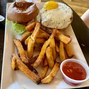 Burger with fried egg and fries