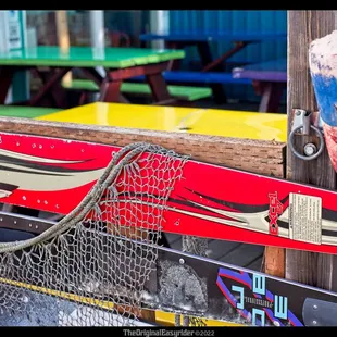 a pair of skis hanging on a fence