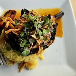 Pork chop bone in with a port braised pears and crispy onions