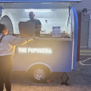 a man standing in front of a food truck