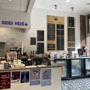 a coffee shop with menus on the wall