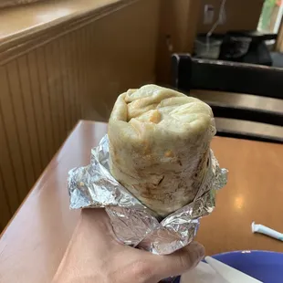 a burrito wrapped in aluminum foil