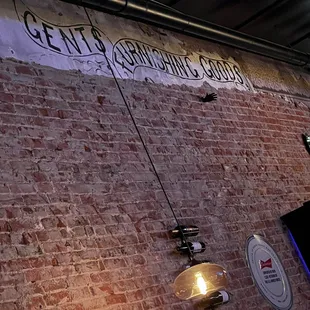 a brick wall with a sign on it