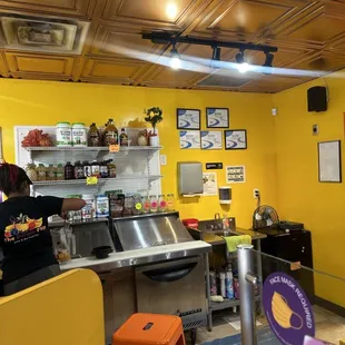 a man preparing food in a yellow kitchen