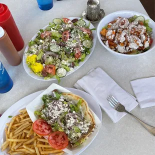 Greek salad, gyro over fries, and chicken and rice bowl.