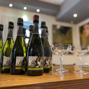 a row of bottles of wine on a bar