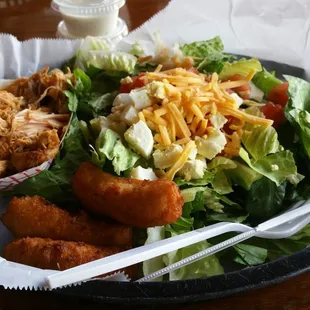 a plate of food with a salad and chicken