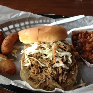 Great pulled pork sandwich with beans and hushpuppies.