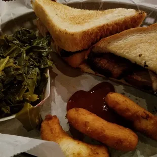 Brisket sandwich with hushpuppies and collard greens. Yummy!