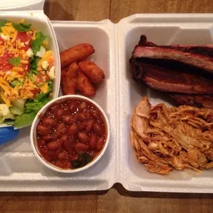 Three meat plate: ribs (4), brisket (4), pulled chicken, with baked beans, salad, and 4 hush puppies. Good prices.