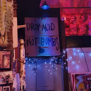 a sign that reads drop acid note bombs