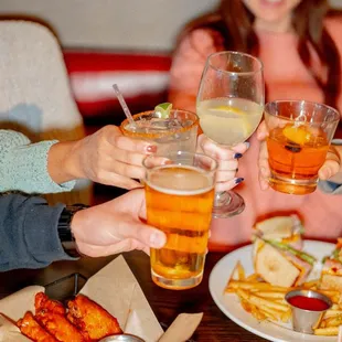 a group of people clinking glasses of beer