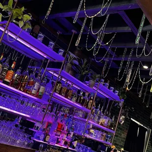 a bar with a lot of bottles of alcohol