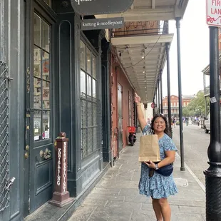Outside signage with Jackson Square in the background. The brown paper bag is hiding the fun packing job they do!