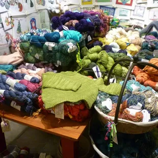 Table filled with the various yarn selections at The Quarter Stitch