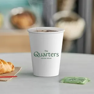 a cup of coffee and a croissant