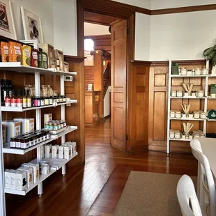 One of the room with a large seating area. Bougie treats, candles, other merchandise.