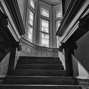 Staircase and windows inside Quarters Coffee Shop next to the coffee counter