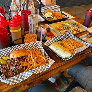 a woman sitting at a table full of food