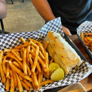 two trays of fries and a sandwich