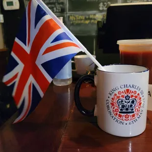 a british flag and a cup of coffee