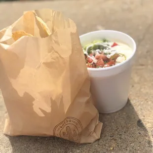 a paper bag and a bowl of soup