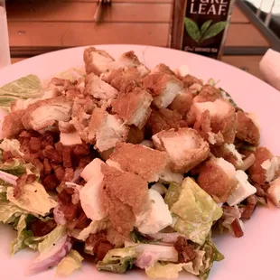 Junk salad (romaine, tomato, cucumber, red onion, bacon, feta, and fried chicken, tossed with Parmesan Peppercorn Ranch)