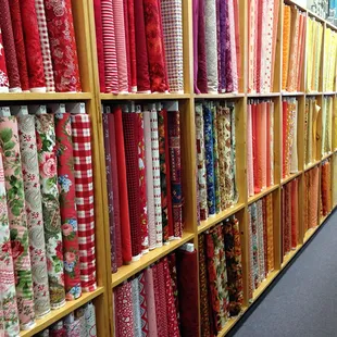 A really excellent selection of fabrics for quilting; this is one section that is organized by main fabric color.