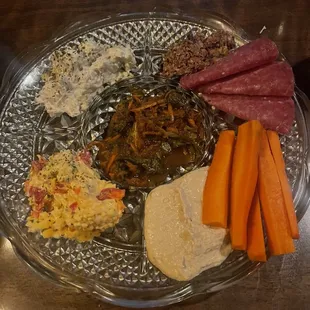 Humus, pimento cheese, pickled greens, artichoke dip, olive tapenade, meat, carrots. Very very good!!