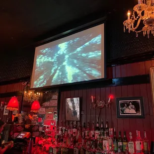 Old movies playing behind the bar