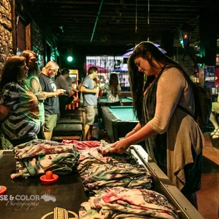 a group of people standing around a table full of fish