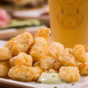 a plate of tater tots and a beer