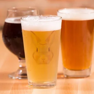 three glasses of beer on a table