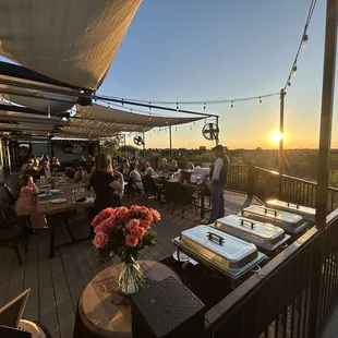 Our buffet setup, guests, and the beautiful sunset over the lake.
