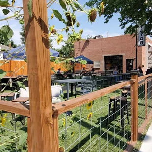 a fenced in area with tables and chairs