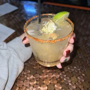 Sparkly gold margarita on the rocks