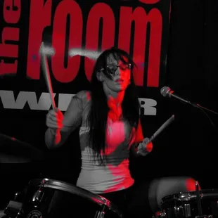 a woman playing drums