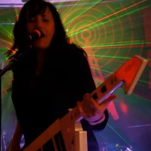 a woman singing into a microphone