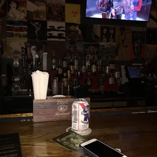 a cell phone and a can of beer