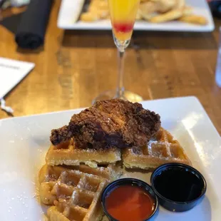 Chicken and waffles with a peach mimosa