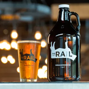 a glass of beer and a growler