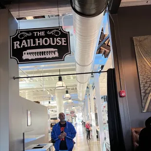 a man standing in the hallway of a restaurant