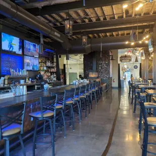 a view of the bar and televisions