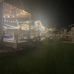 More of the outdoor area with bar and stage. Fake grass on the sides.